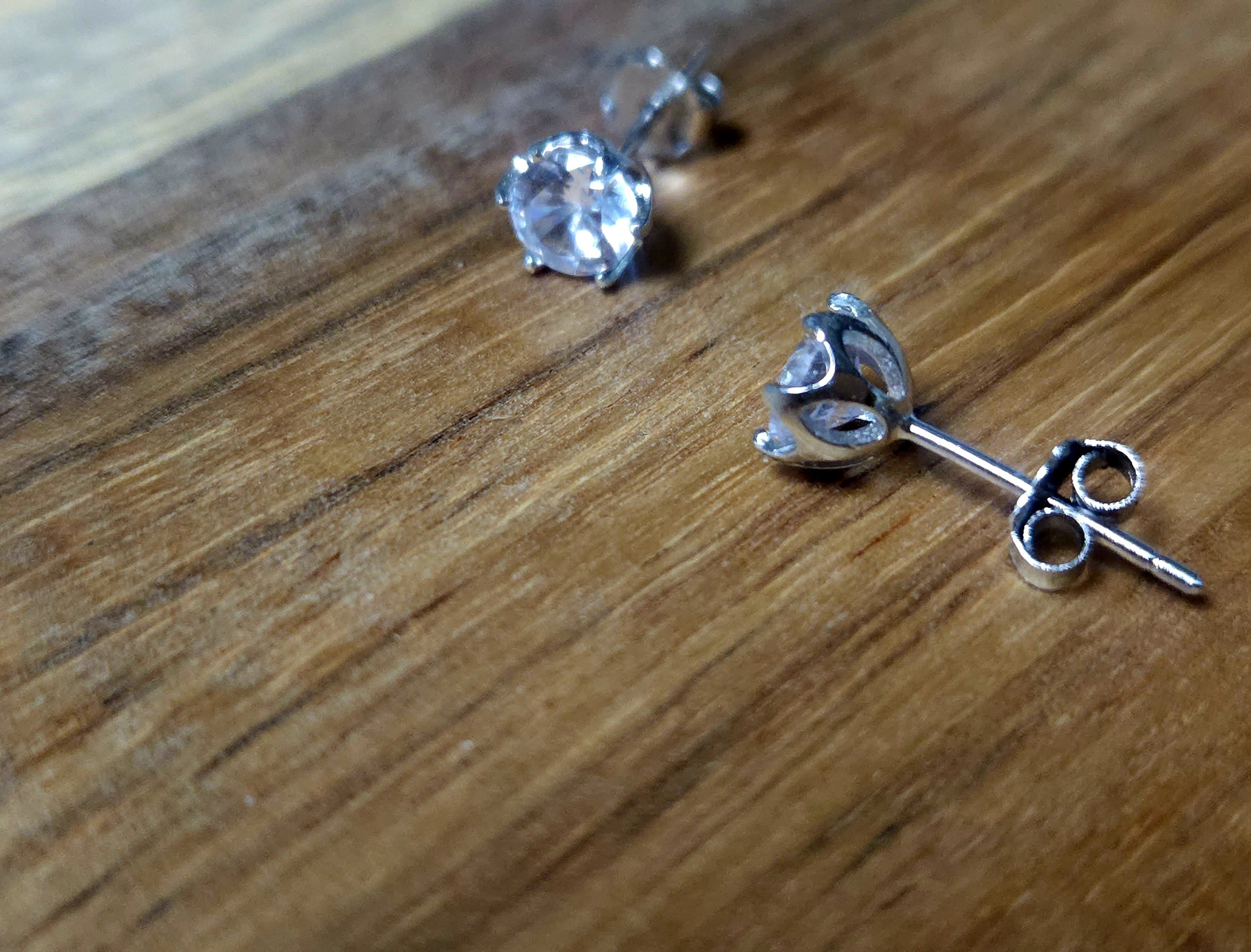 sterling silver and cubic zirconia earrings on a wood table