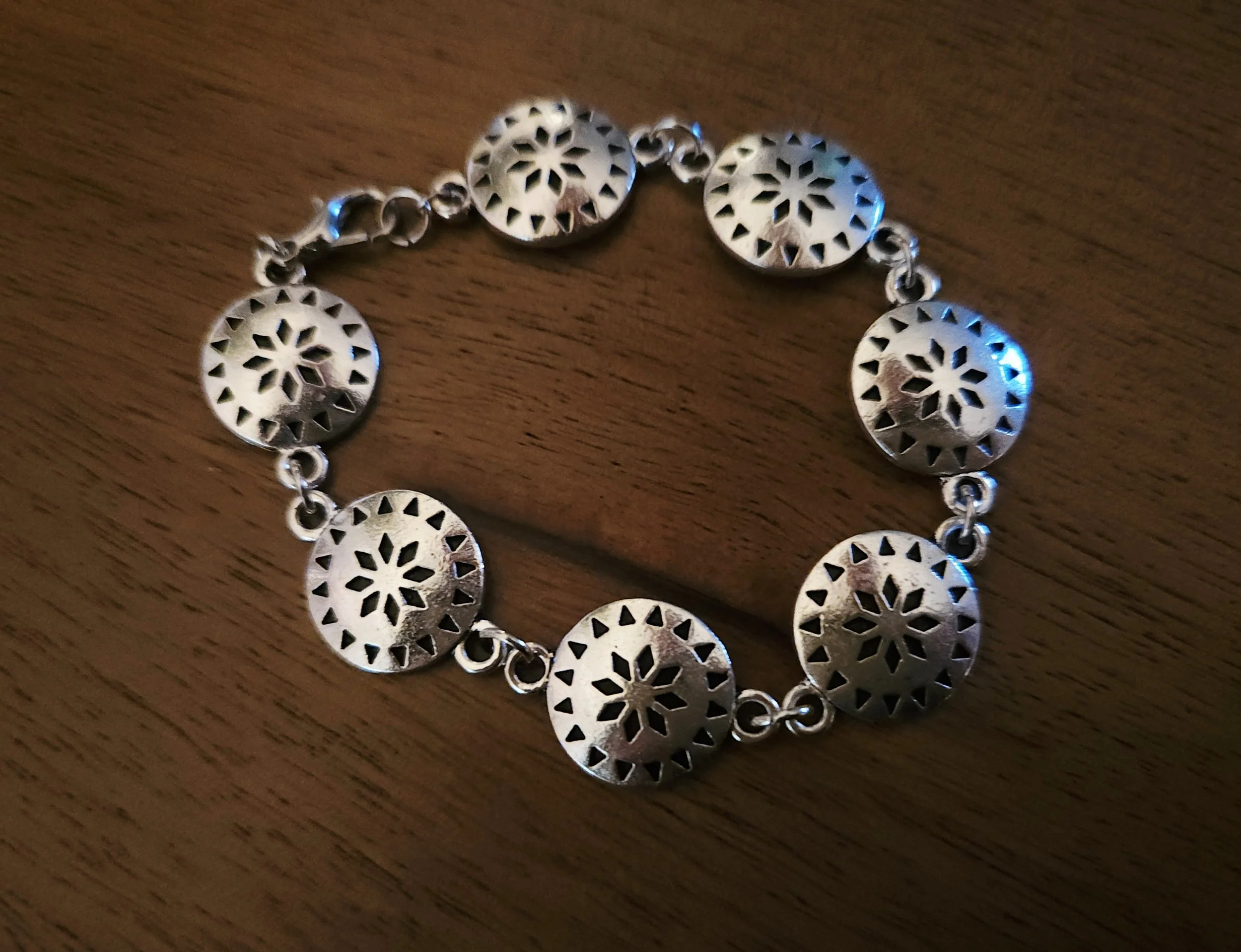 Western-inspired silver concho bracelet with detailed floral pattern
