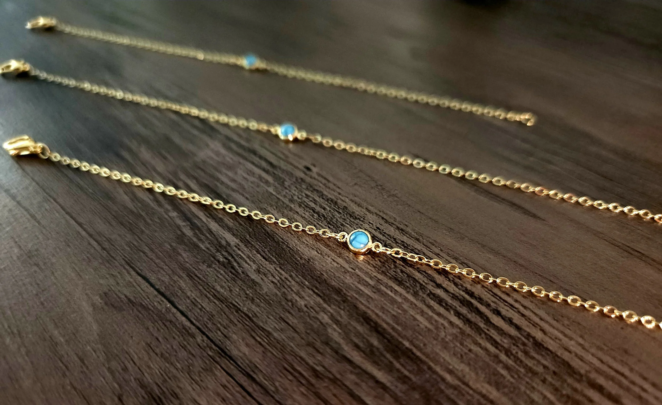 turquoise pendant on a gold chain bracelet