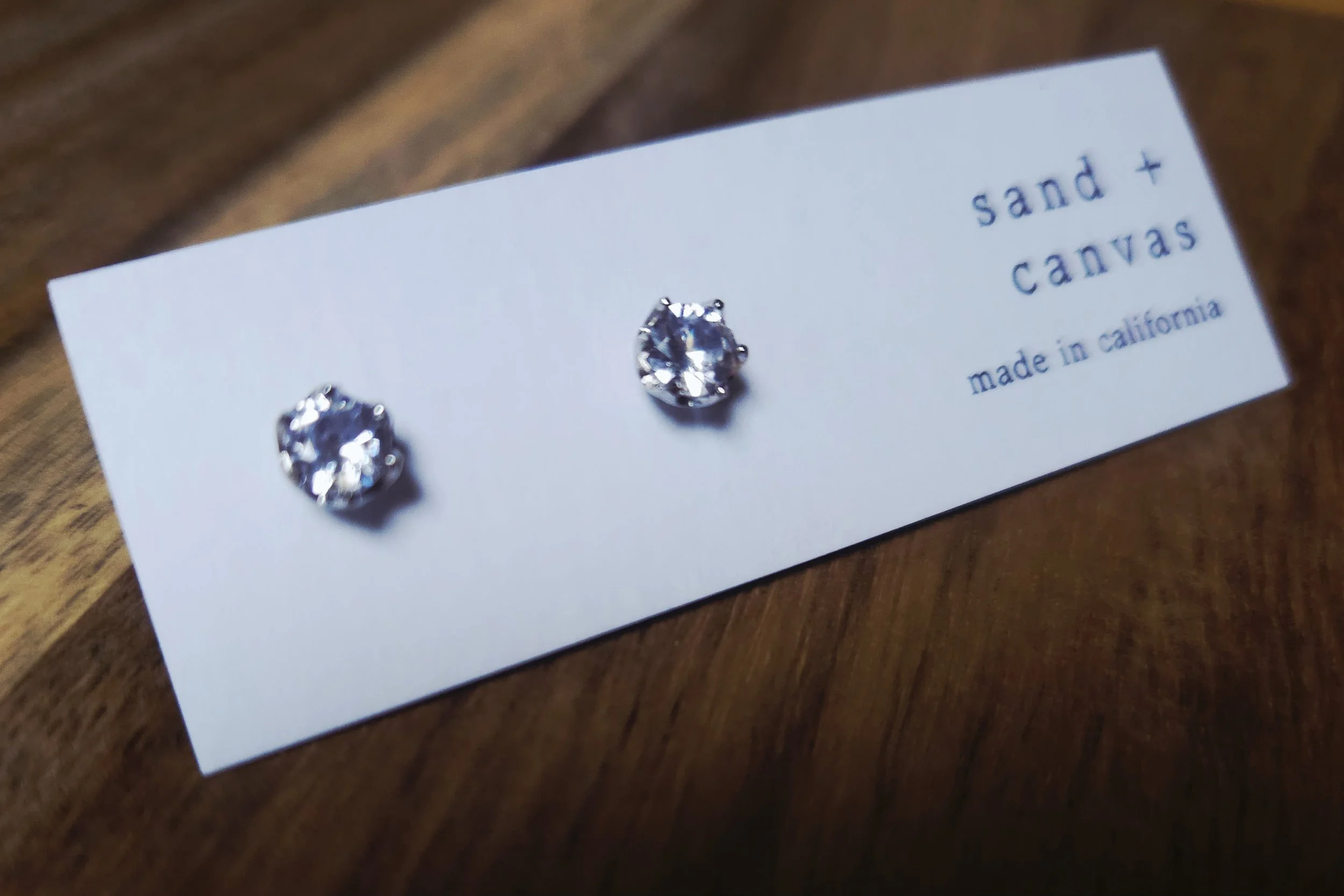 sterling silver and cubic zirconia earrings with a silver lotus design