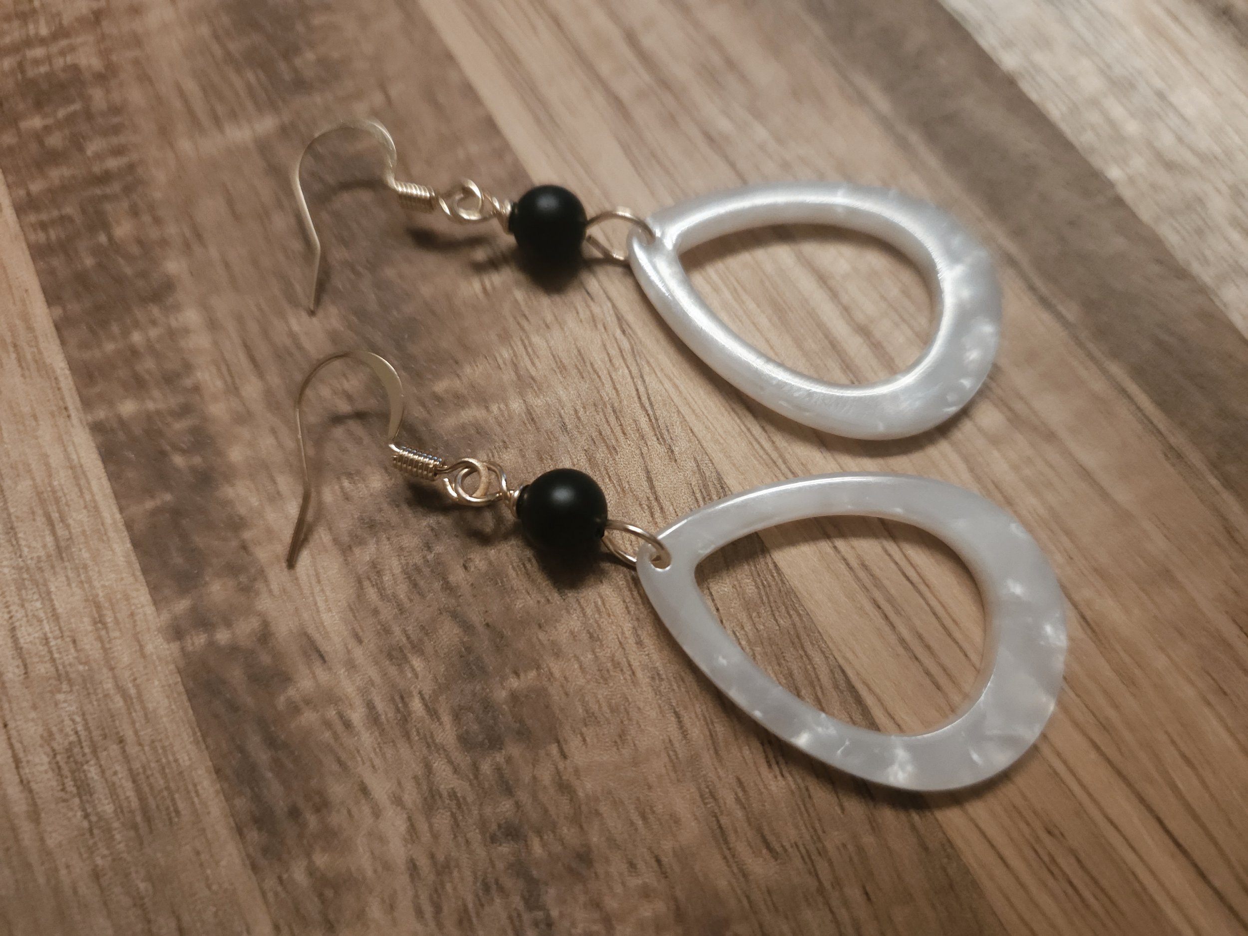 white tear drop earrings with black beads and gold