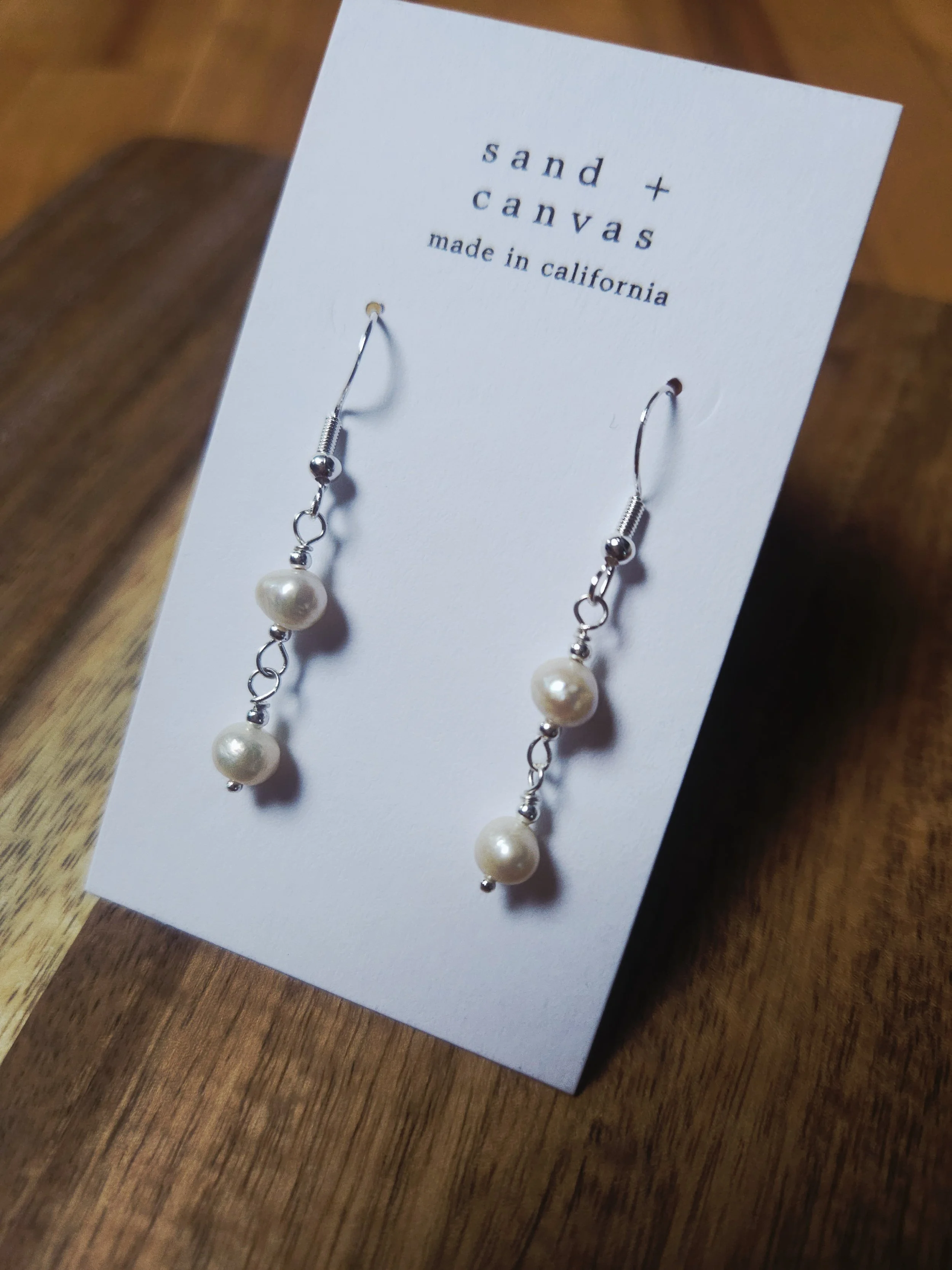 pearl earrings on a white background tabletop