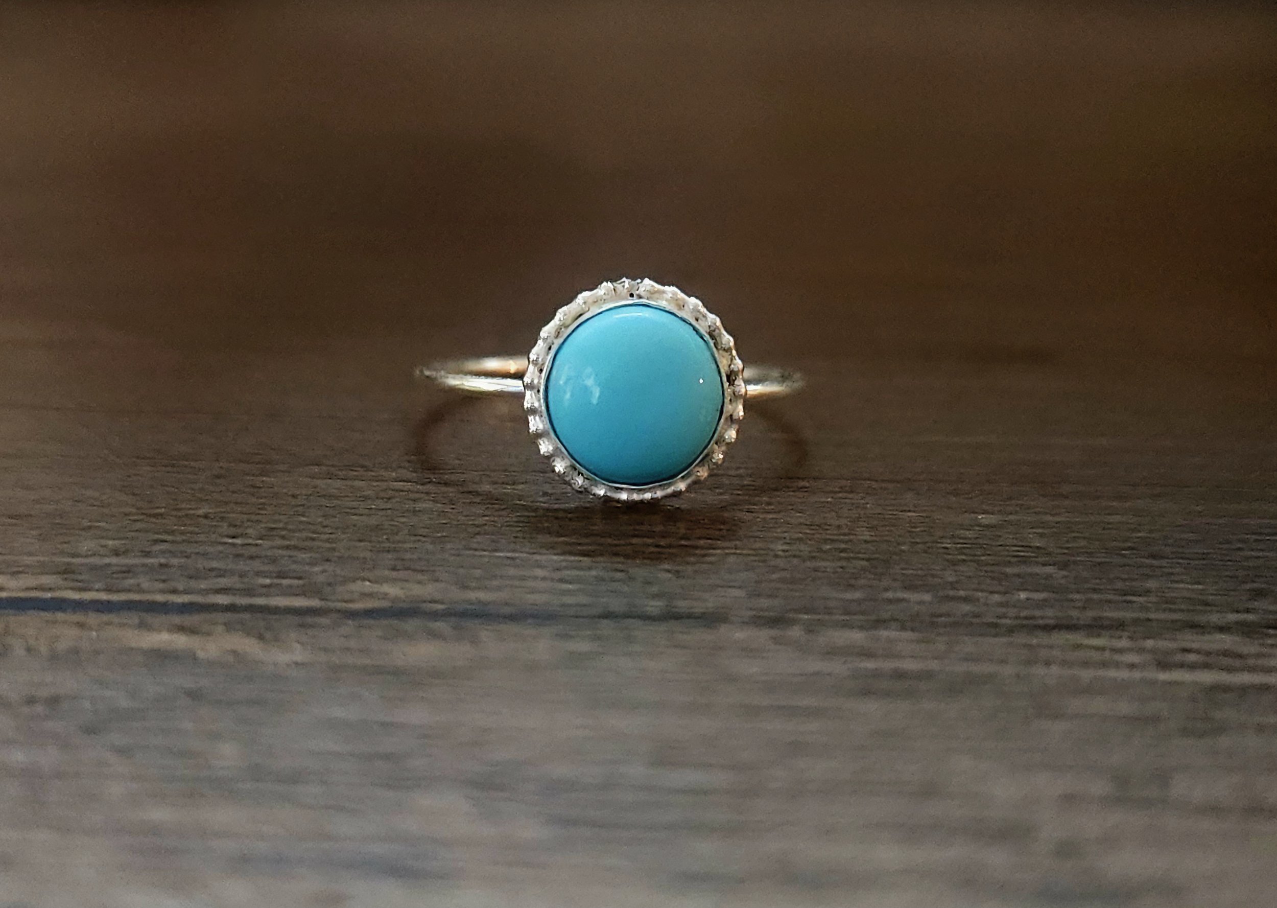 Turquoise and silver ring with beaded edging sand and canvas