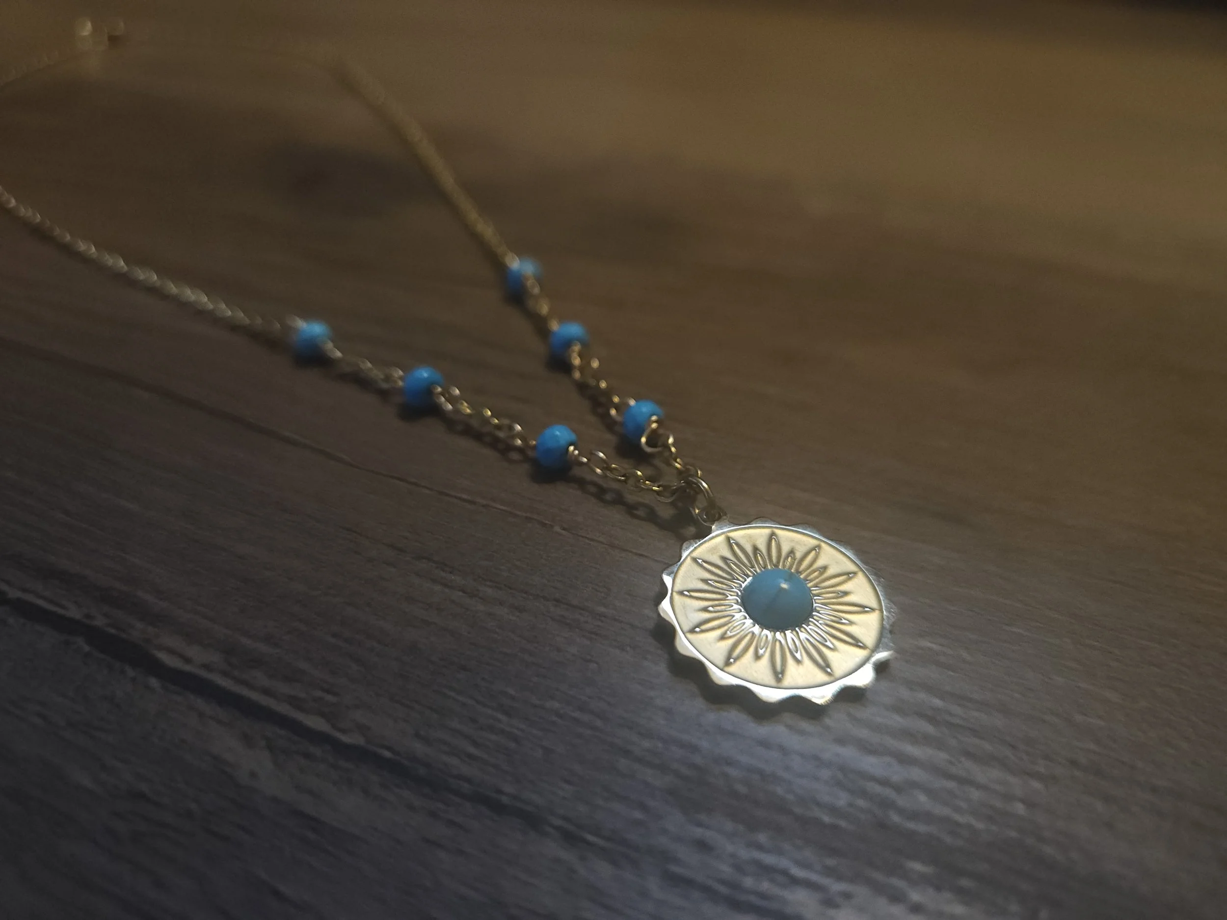 cowgirl necklace with howlite and gold on a wooden table