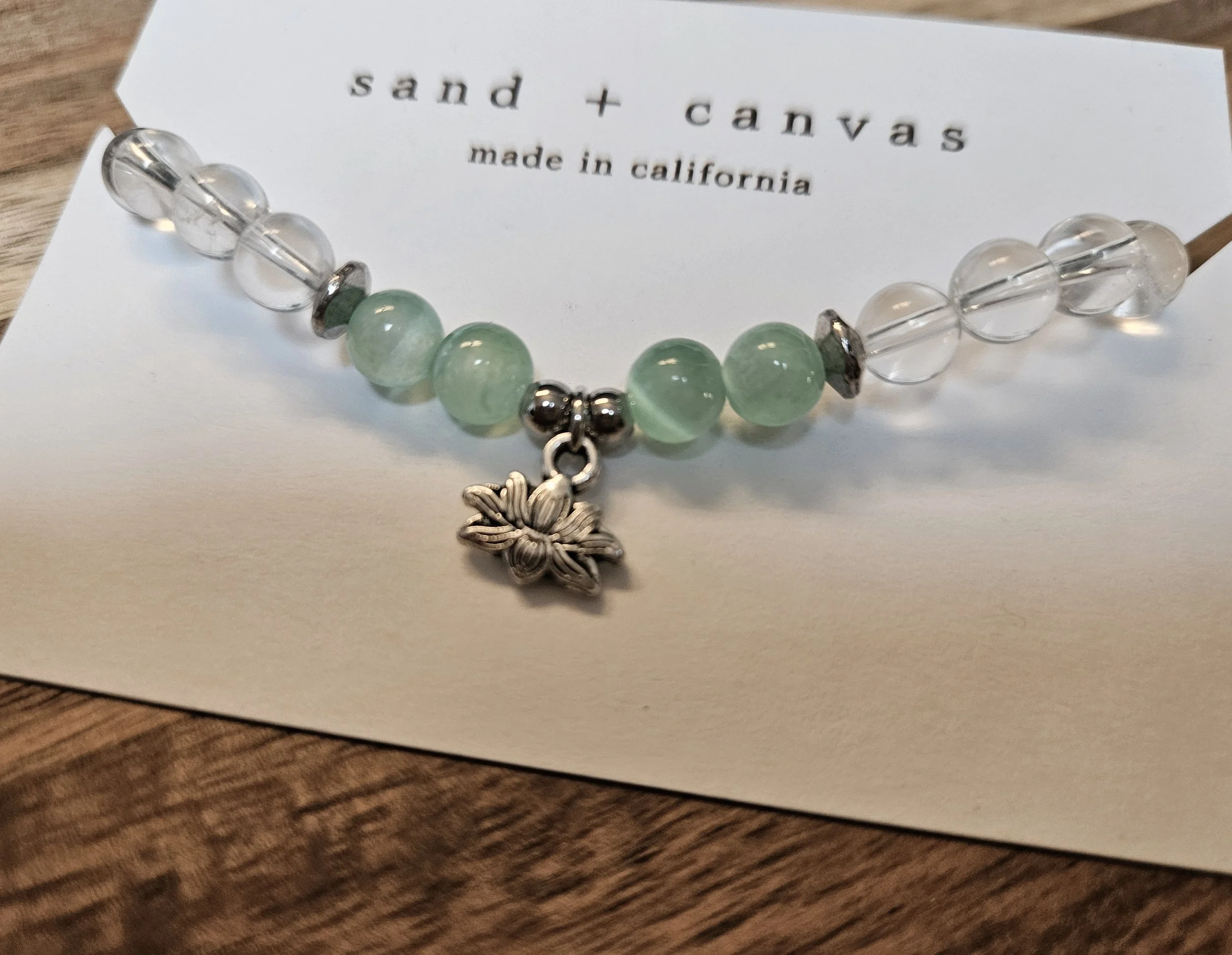 beaded chakra bracelet with clear quartz and green selenite with a lotus