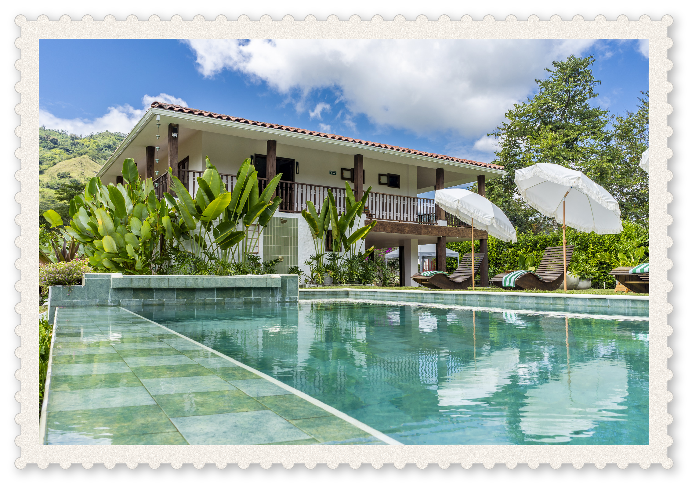 view of the beautiful pool with the casa that sleeps 17 in quimbaya, quindio