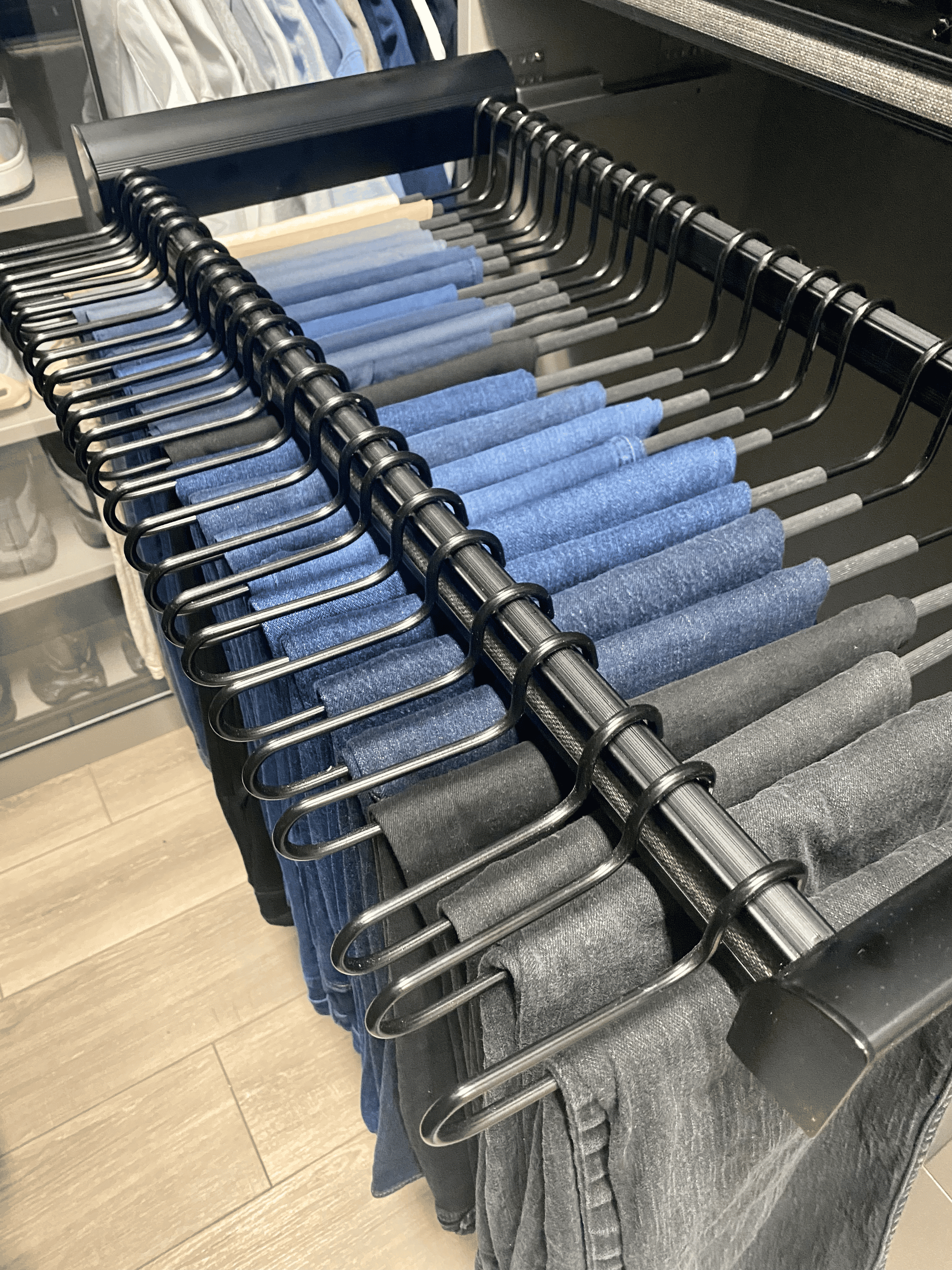 Pull-out pants hanger system installed as part of closet organization in Austin Texas home
