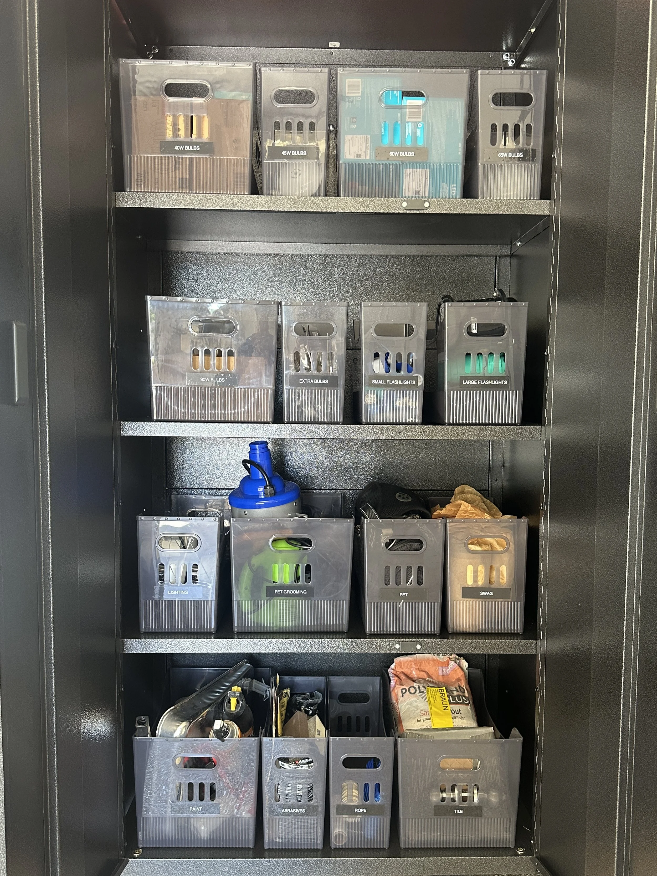 Garage storage cabinet with labeled bins organized by Austin home organizer