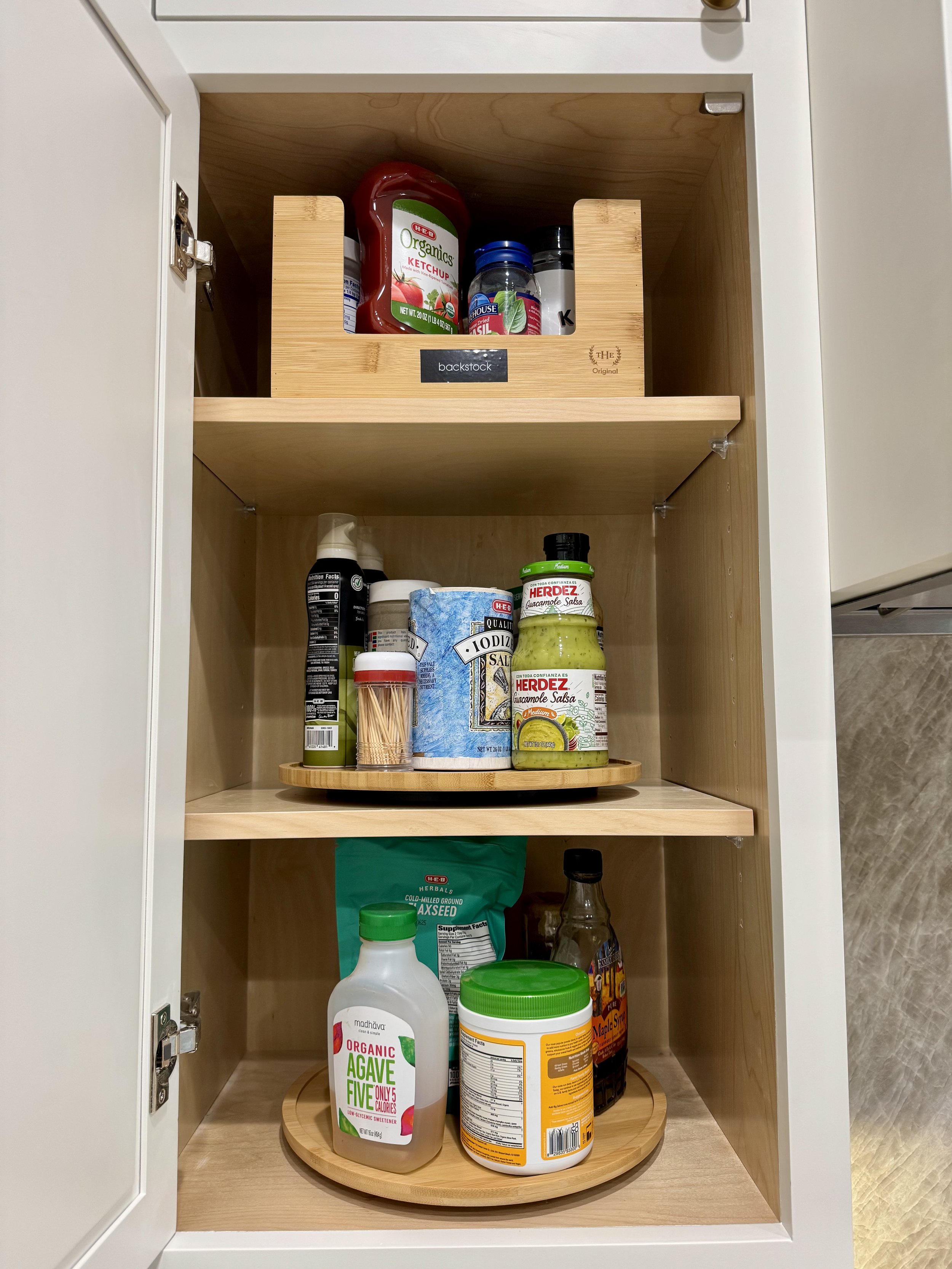 Kitchen cabinet organization with lazy susan storage by Austin professional organizer