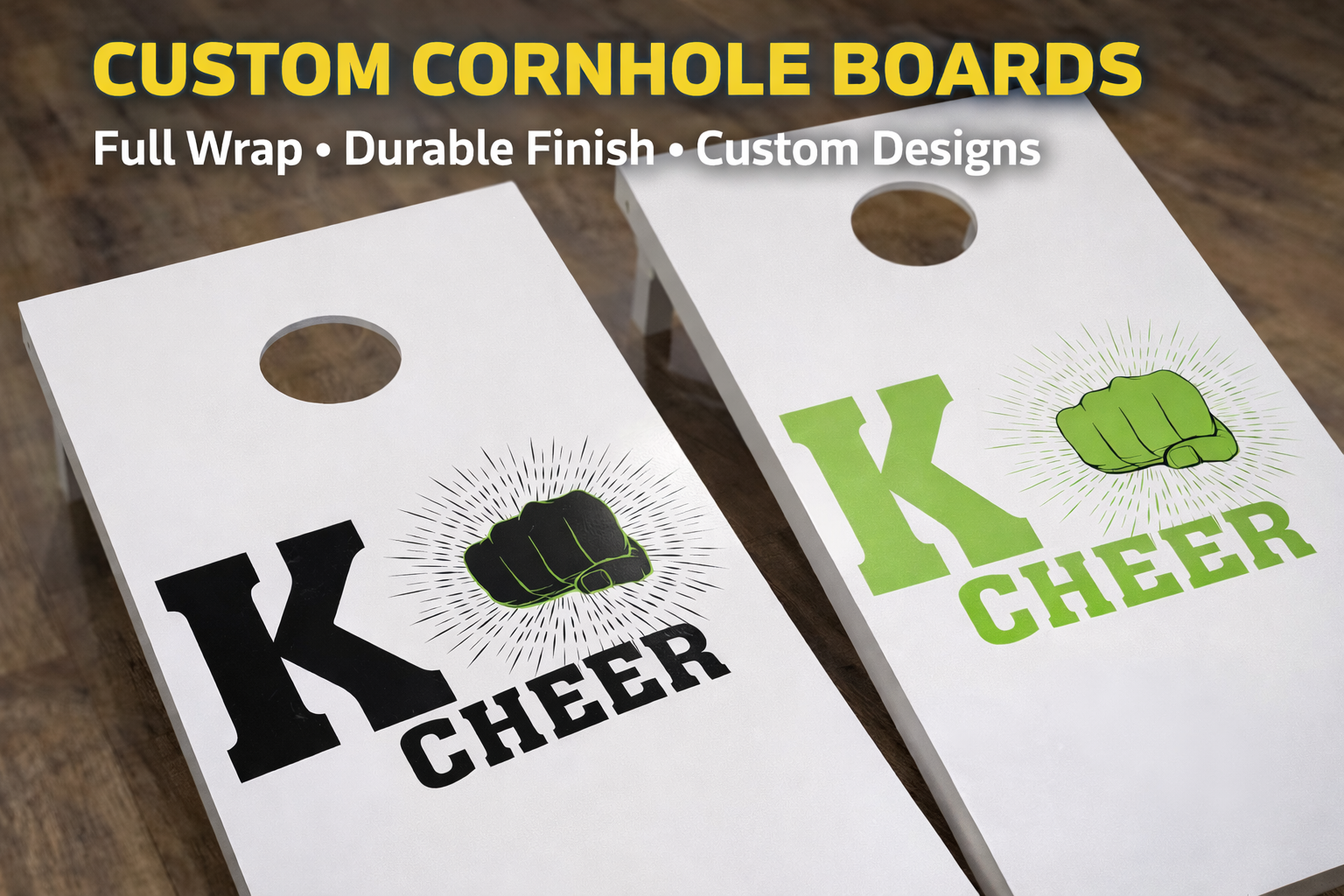 Two custom cornhole boards, one with black lettering and a green fist graphic, the other with green lettering and a matching green fist graphic, on a wooden surface.