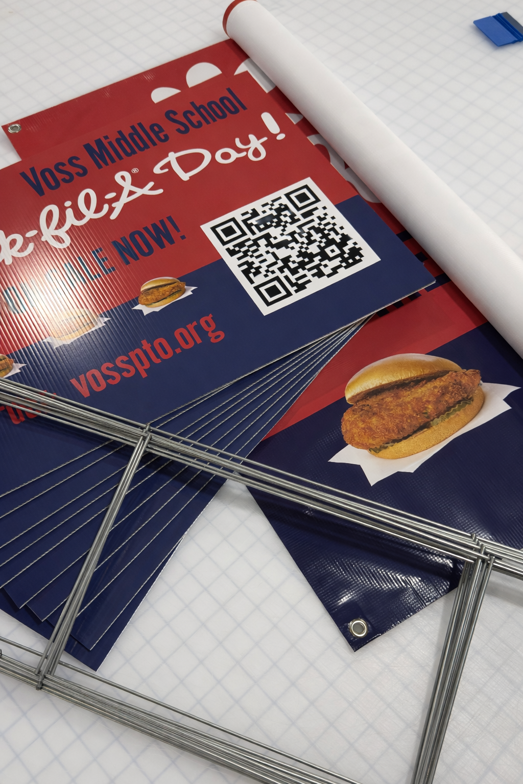 Flyers for Voss Middle School's upcoming event, featuring a QR code and an image of a fried chicken sandwich on a paper wrapper.