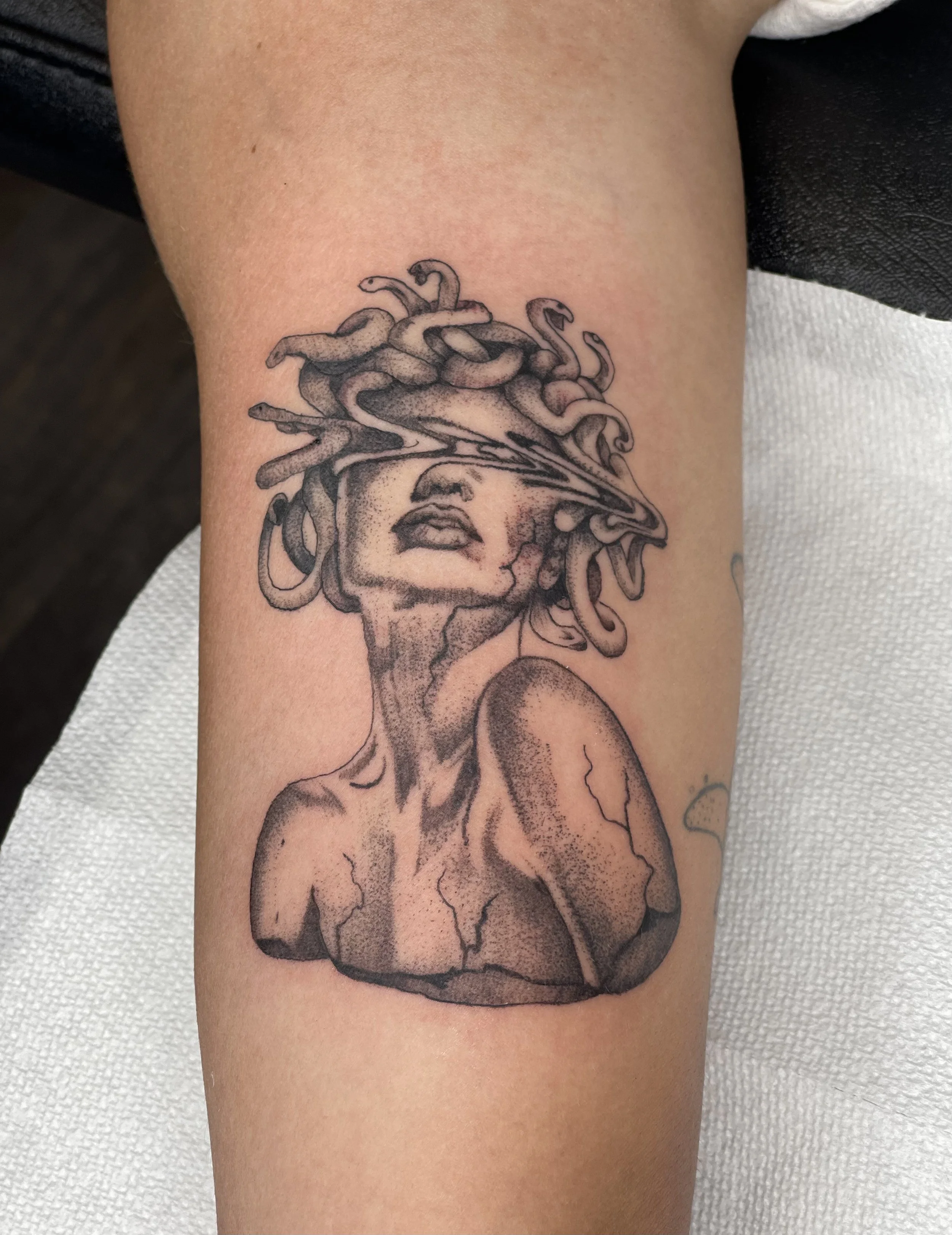 Close-up photograph of medusa tattoo  on forearm