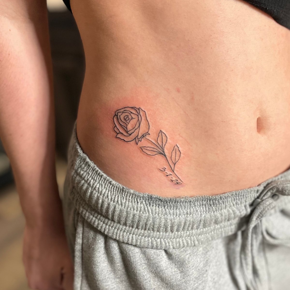 rose tattoo in Lower stomach.jpg