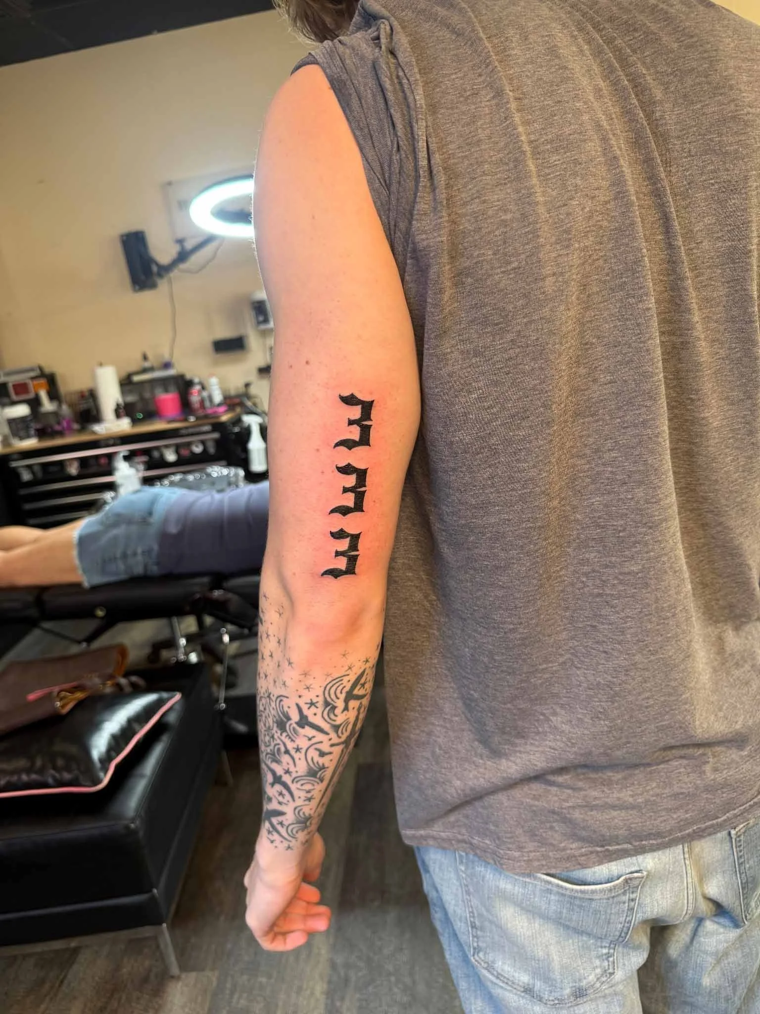 Numeric lettering tattoo on a man's arm