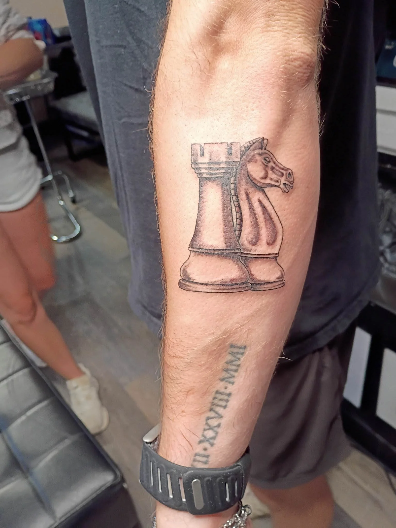 Detailed forearm chess pieces tattoo close-up