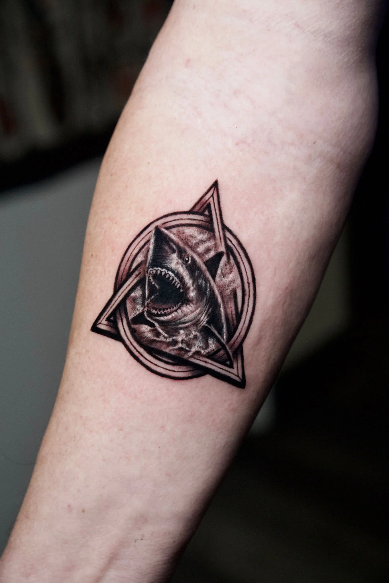 Close-up of an intricate geometric triangle blackwork tattoo
