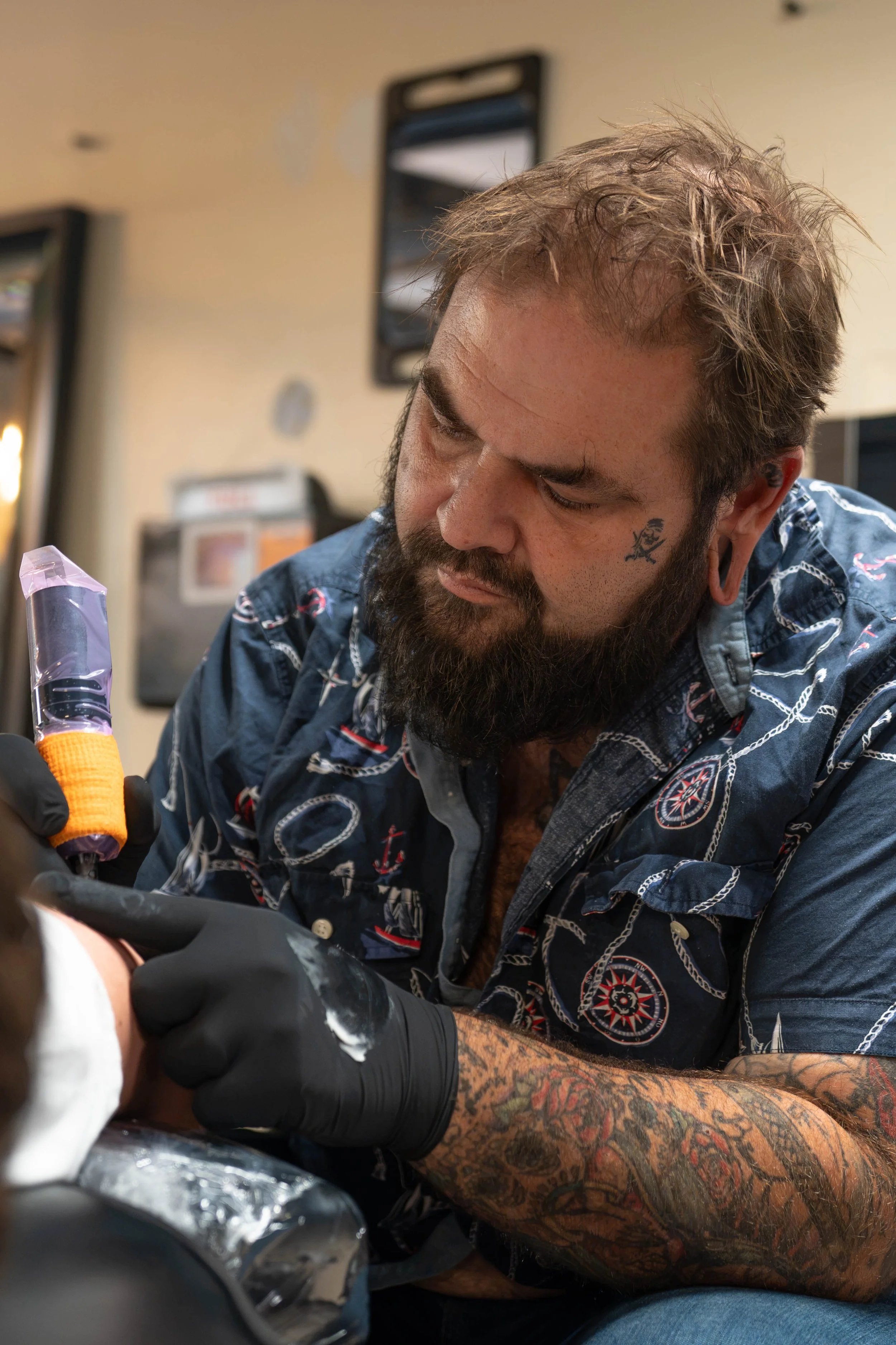tj connors doing arm tattoo