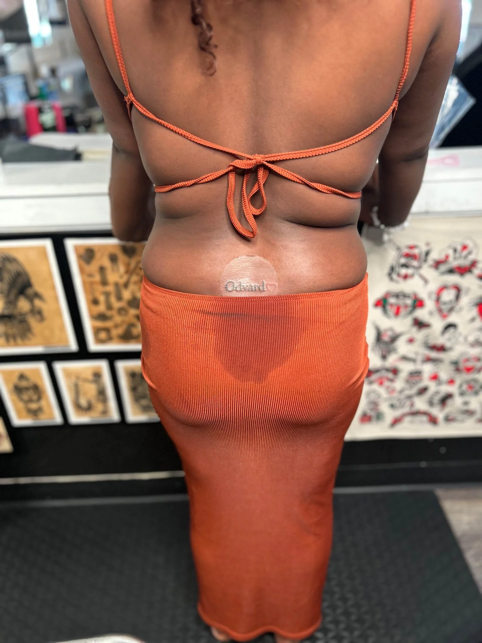 Minimalist tattoo on woman's lower back