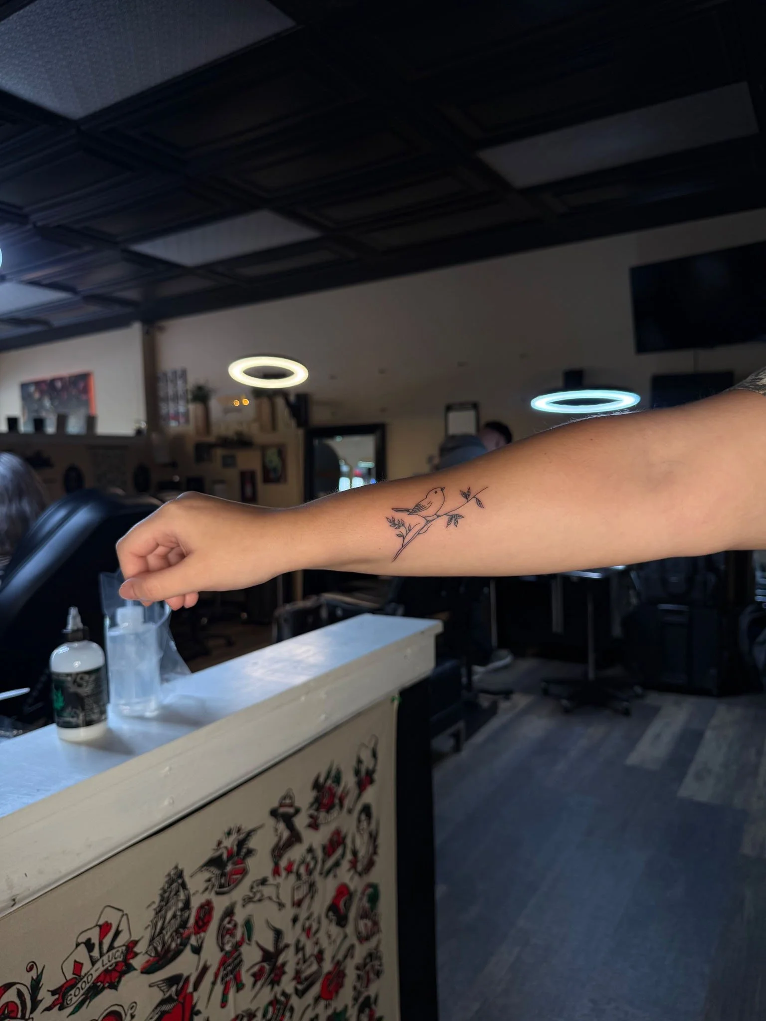 Fresh bird on a branch fineline tattoo