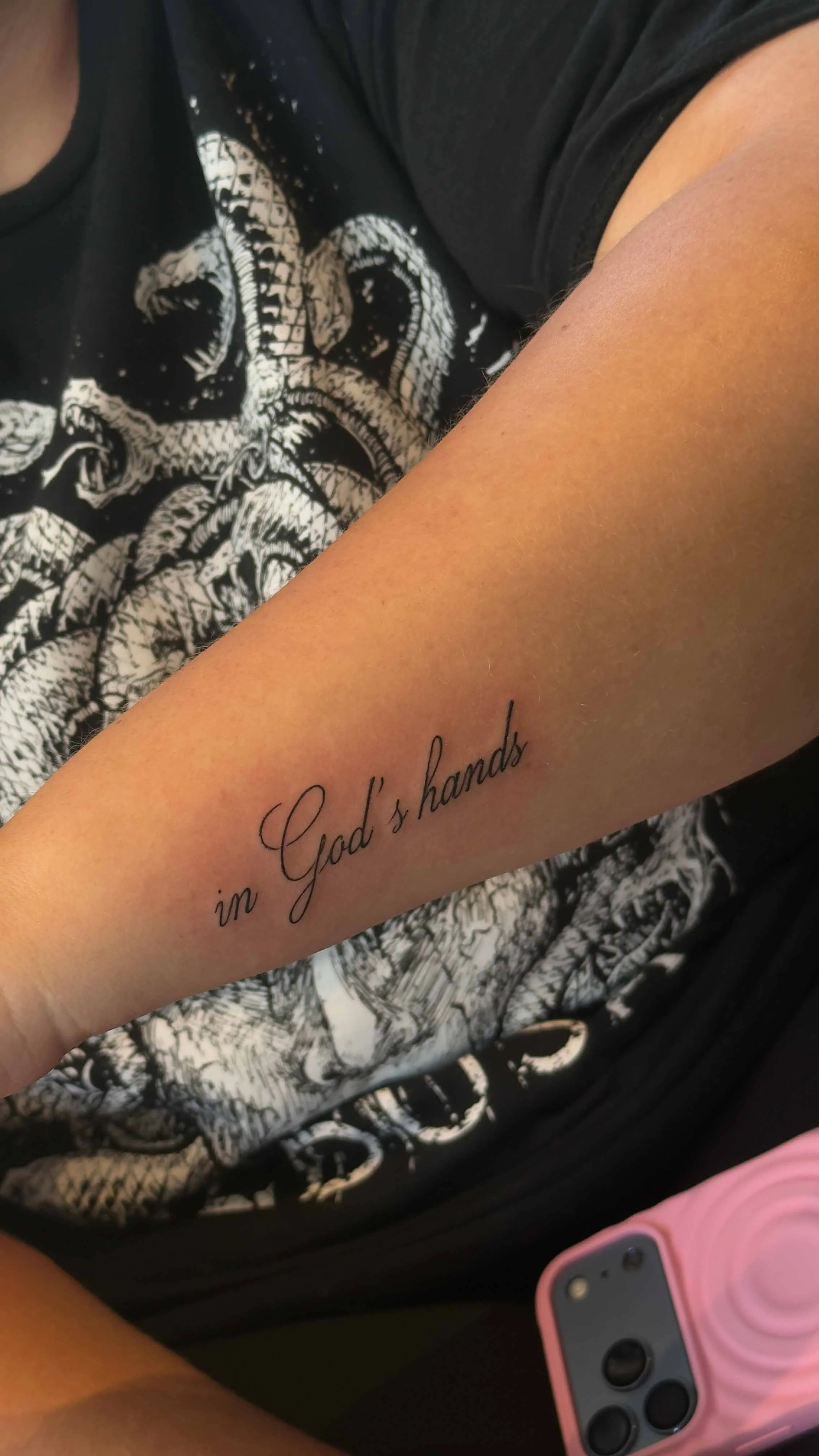script tattoo in forearm "in God's hands"