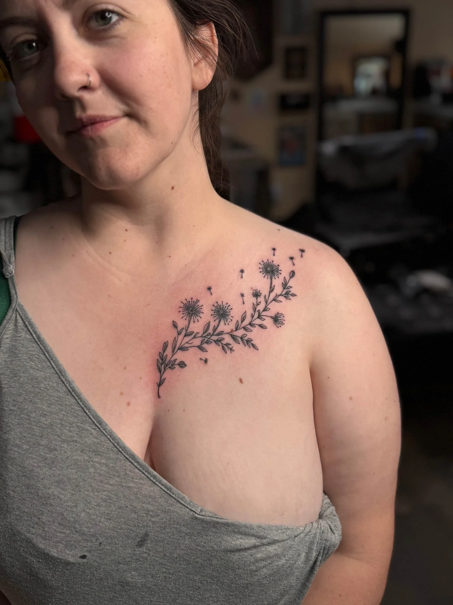 Small floral tattoo design on a person's upper chest