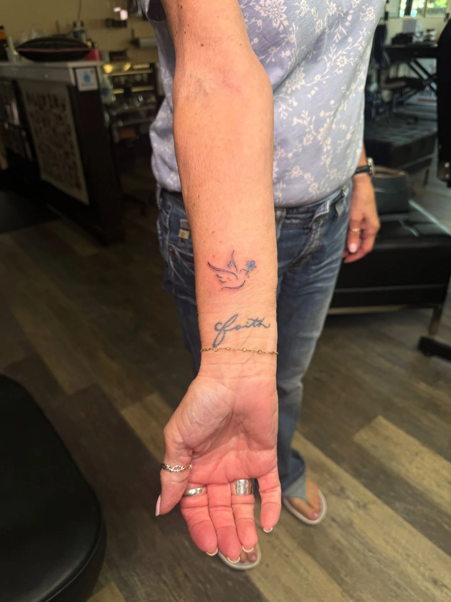 Forearm tattoo shown in a studio setting.