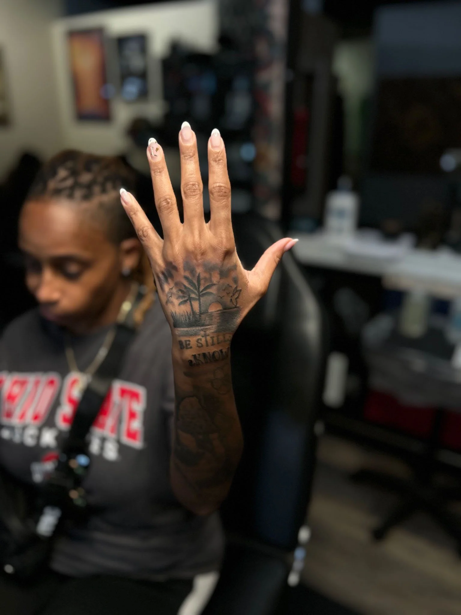 Detailed black and gray tattoo covering the back of a hand