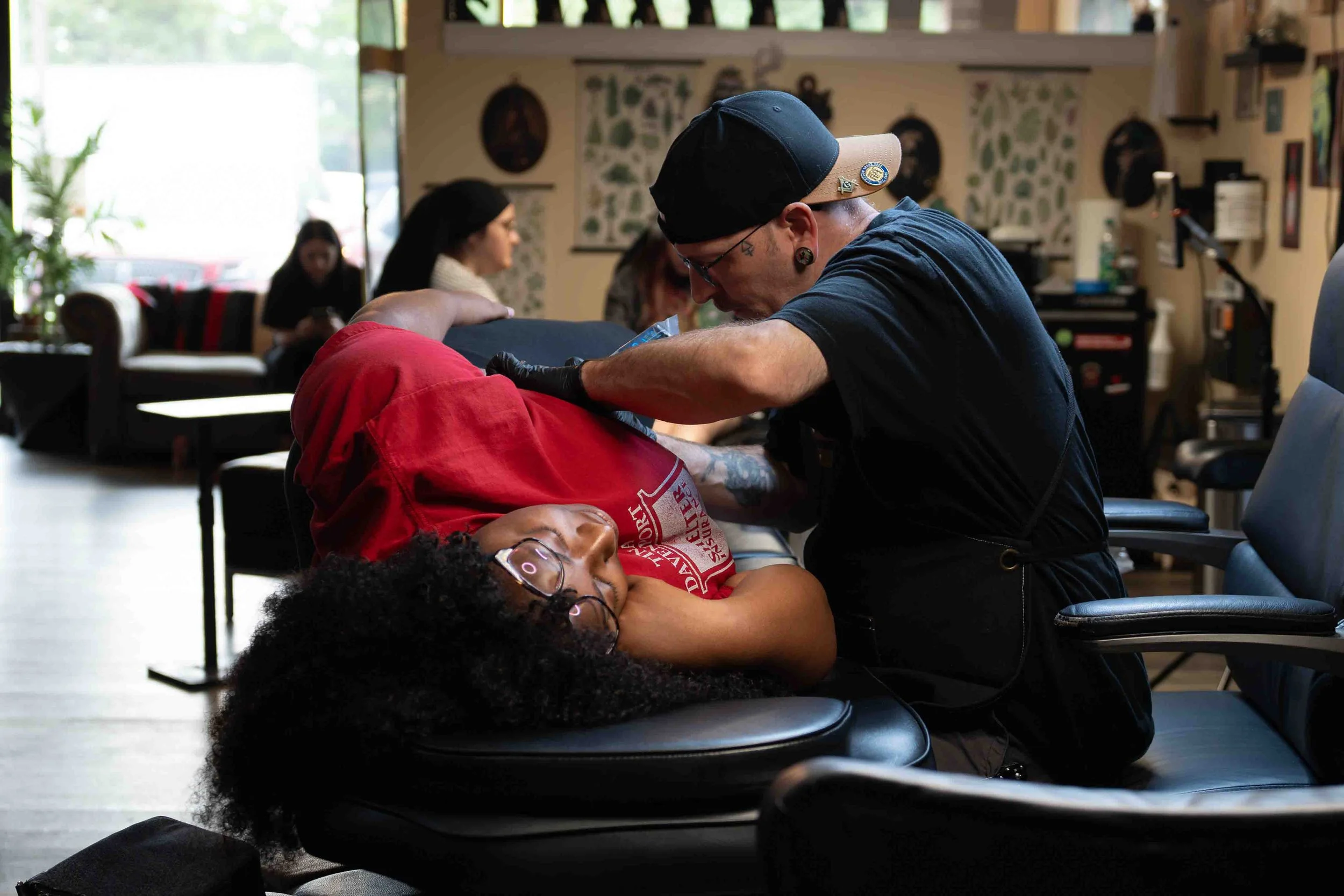 Client receiving a tattoo in a studio