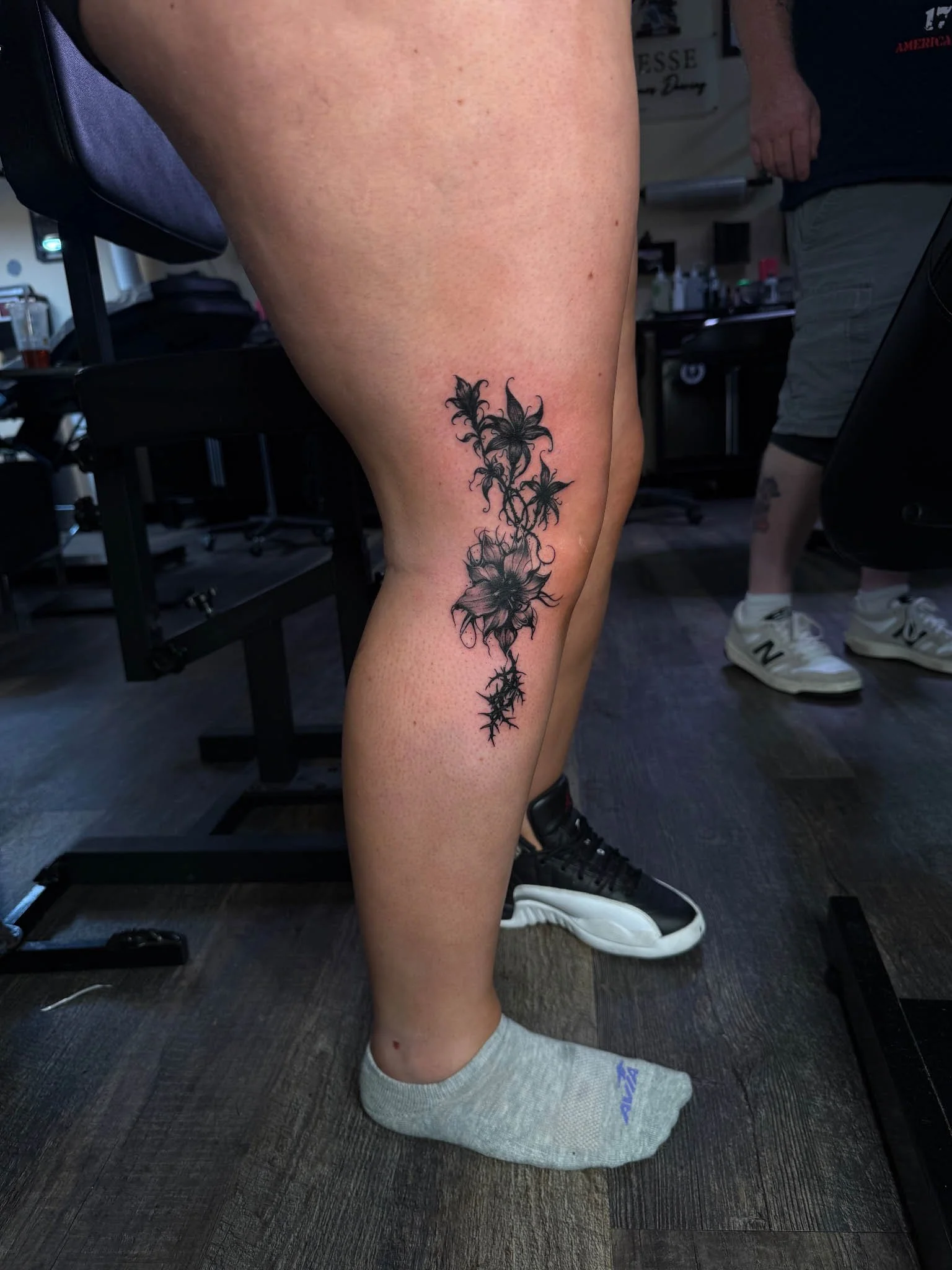 Fresh dark gothic tattoo on leg