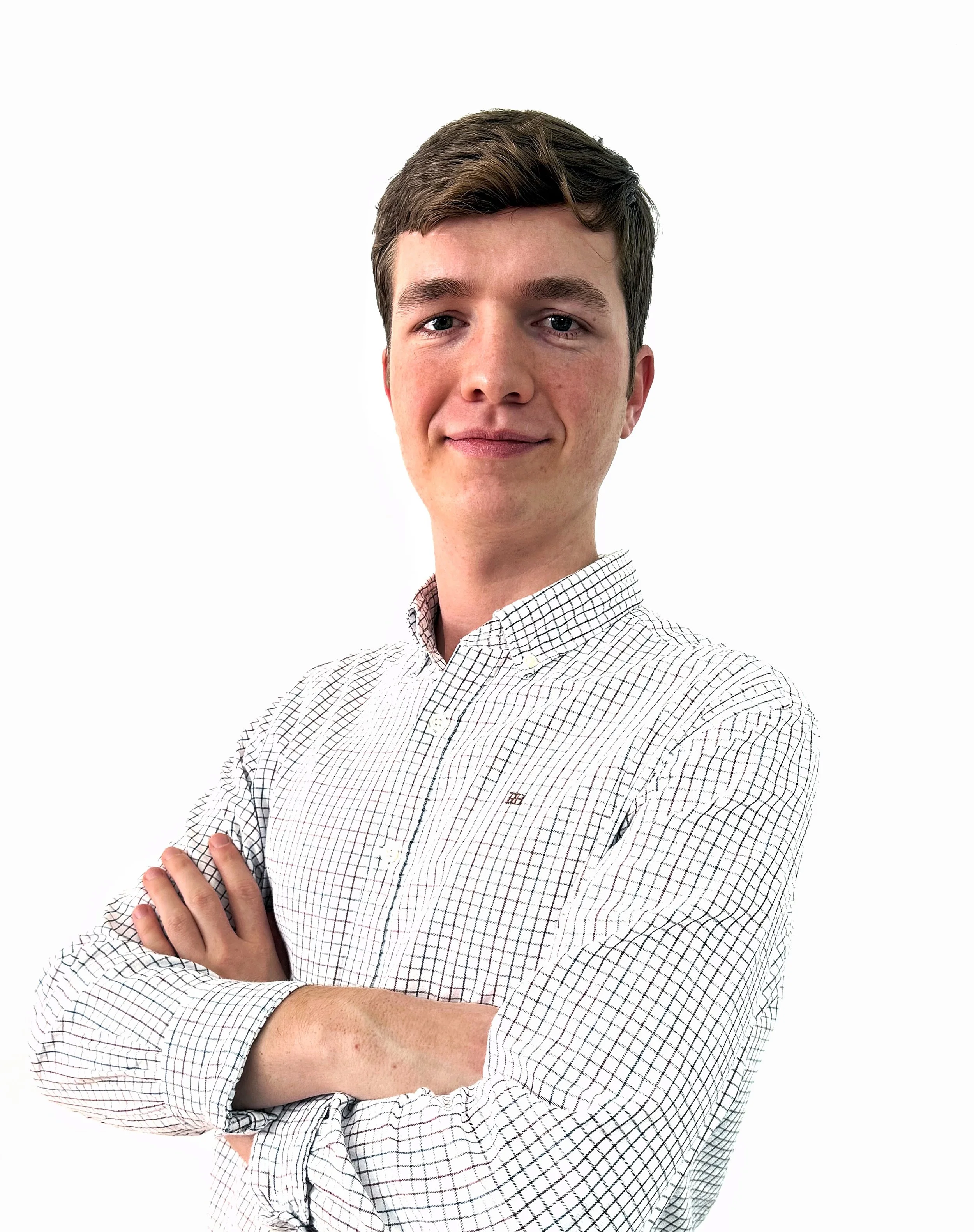 Snow-covered mountains surrounding a calm, reflective lake with a partly cloudy sky overhead.