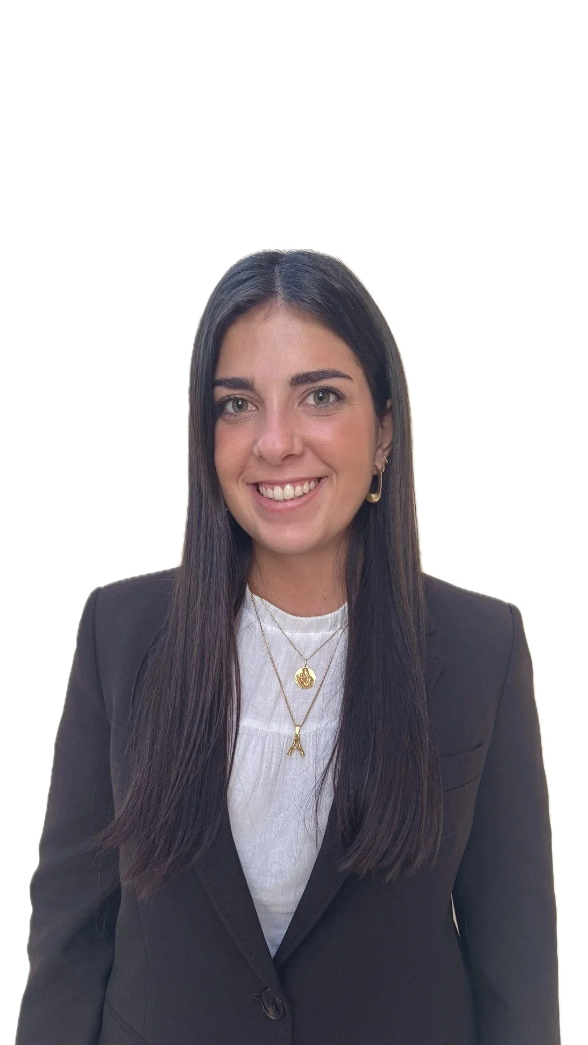 Black and white aerial photo of six people rowing a long, narrow boat in open water.