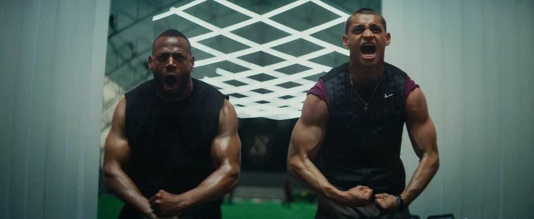 Two men flexing their muscles and shouting