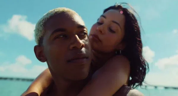 A man and woman embracing on the beach in the film Waves