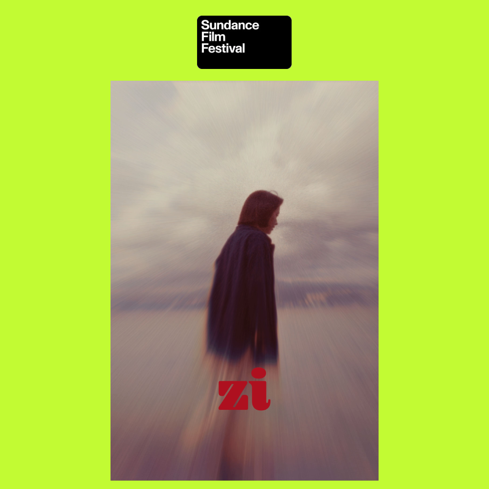 A woman with shoulder-length hair wearing a dark coat stands outdoors facing left with a cloudy sky behind her. The background has a motion blur effect. There is a black box at the top with white text that reads "Sundance Film Festival." The letters 