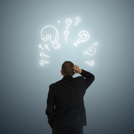 A man in a suit scratches his head, surrounded by glowing question marks, representing confusion or problem-solving