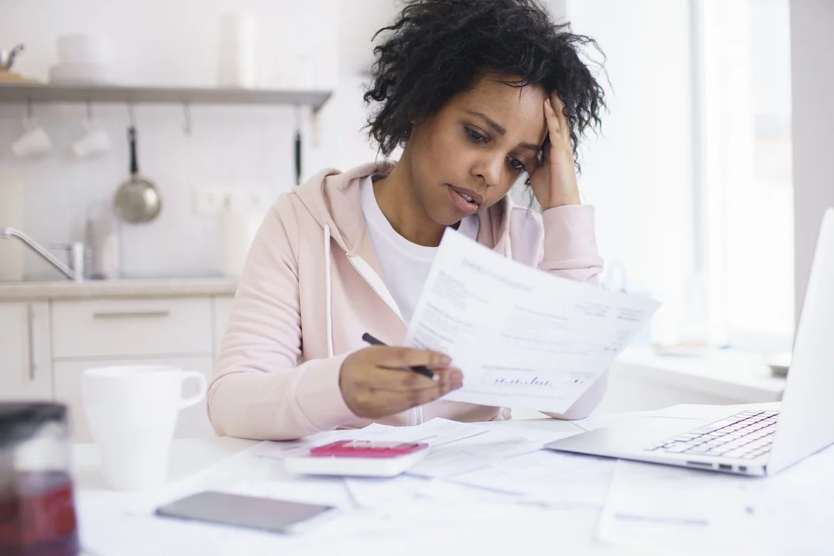A woman looking at her medical insurance bills.
