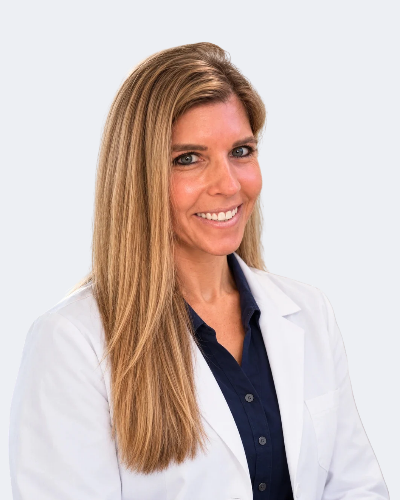 Westchester concierge gynecologist Dr. Nikole Ostrov in a white coat and navy shirt