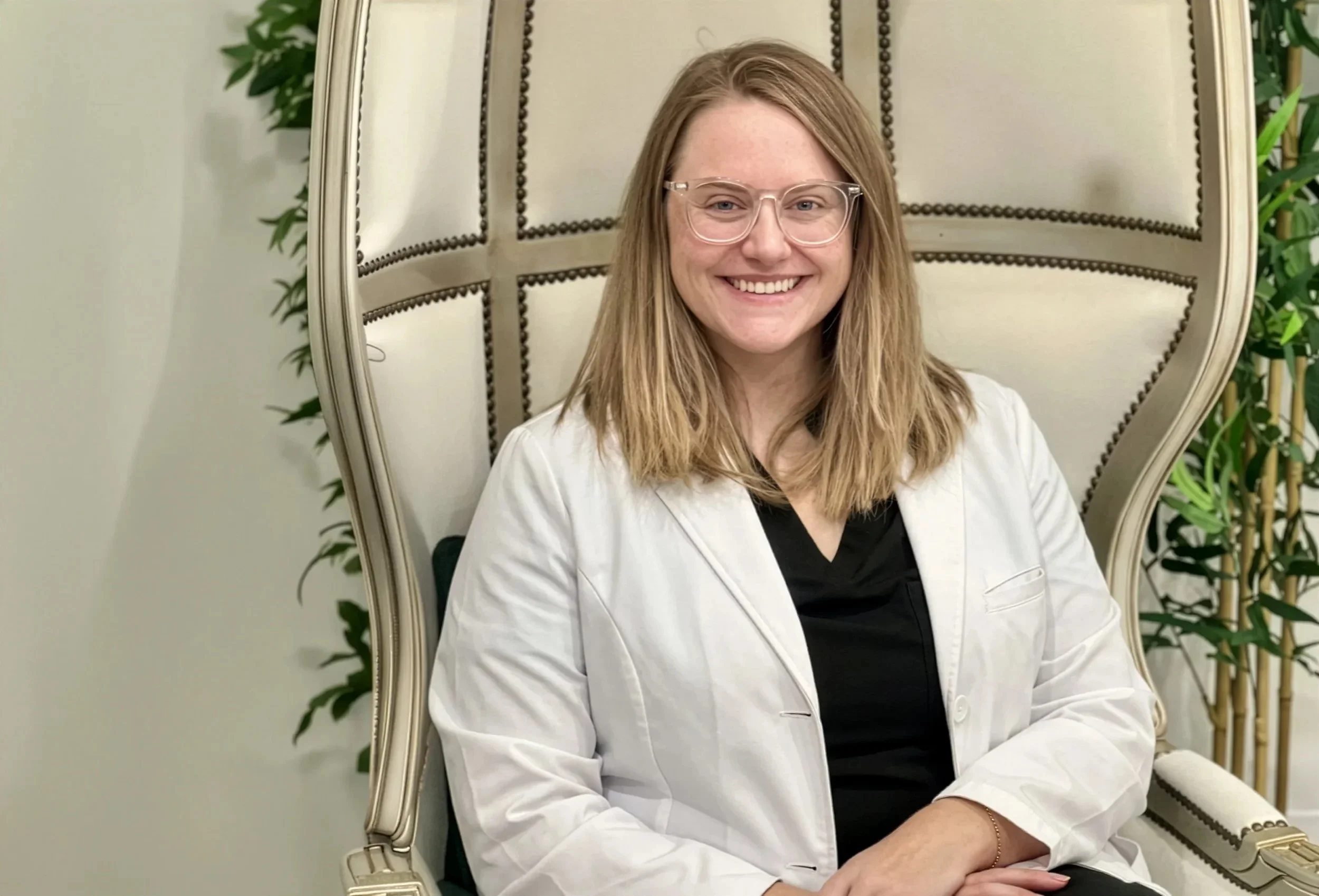 Preventive and metabolic health nurse practitioner Amanda Dunn seated in a cream chair at Clover Family Medicine