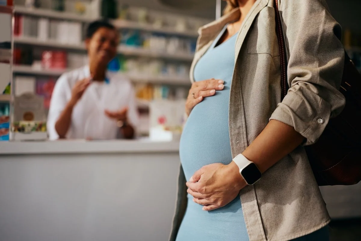 A pregnant woman at the pharmacy