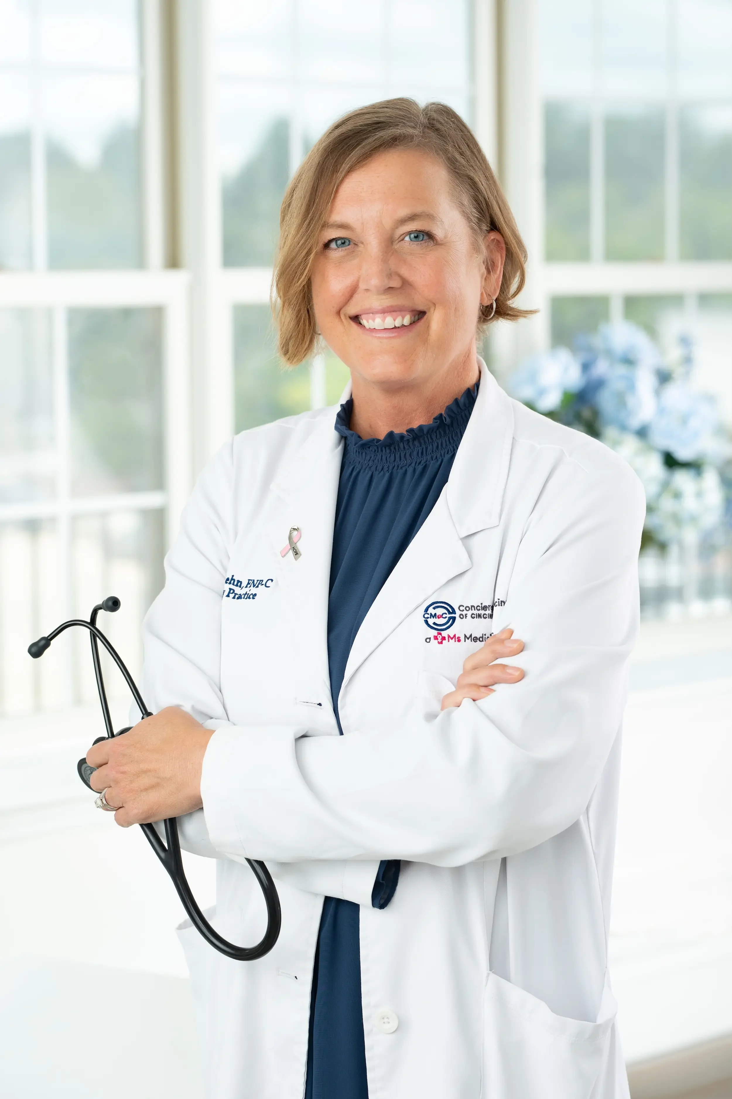 Ronda Lehn, FNP-C, smiling in a navy dress, nurse practitioner at a Ms.Medicine concierge practice in Cincinnati, Ohio