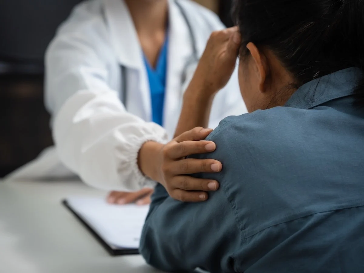 A doctor comforting a patient with a diabetes diagnosis.