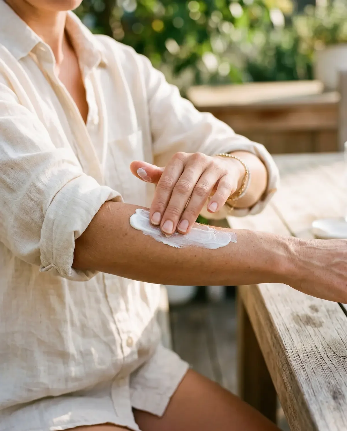 Woman applying mineral sunscreen to forearm outdoors — Ms.Medicine guide to how sunscreen works