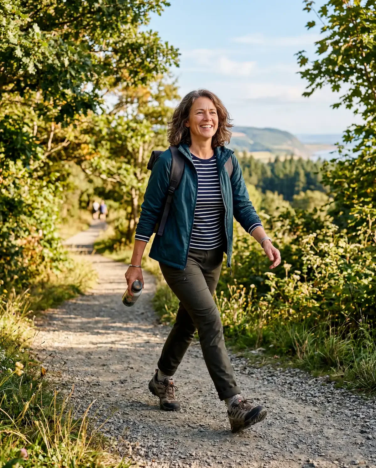 Active woman in her late 40s walking outdoors representing strength mobility and quality of life with arthritis management for women