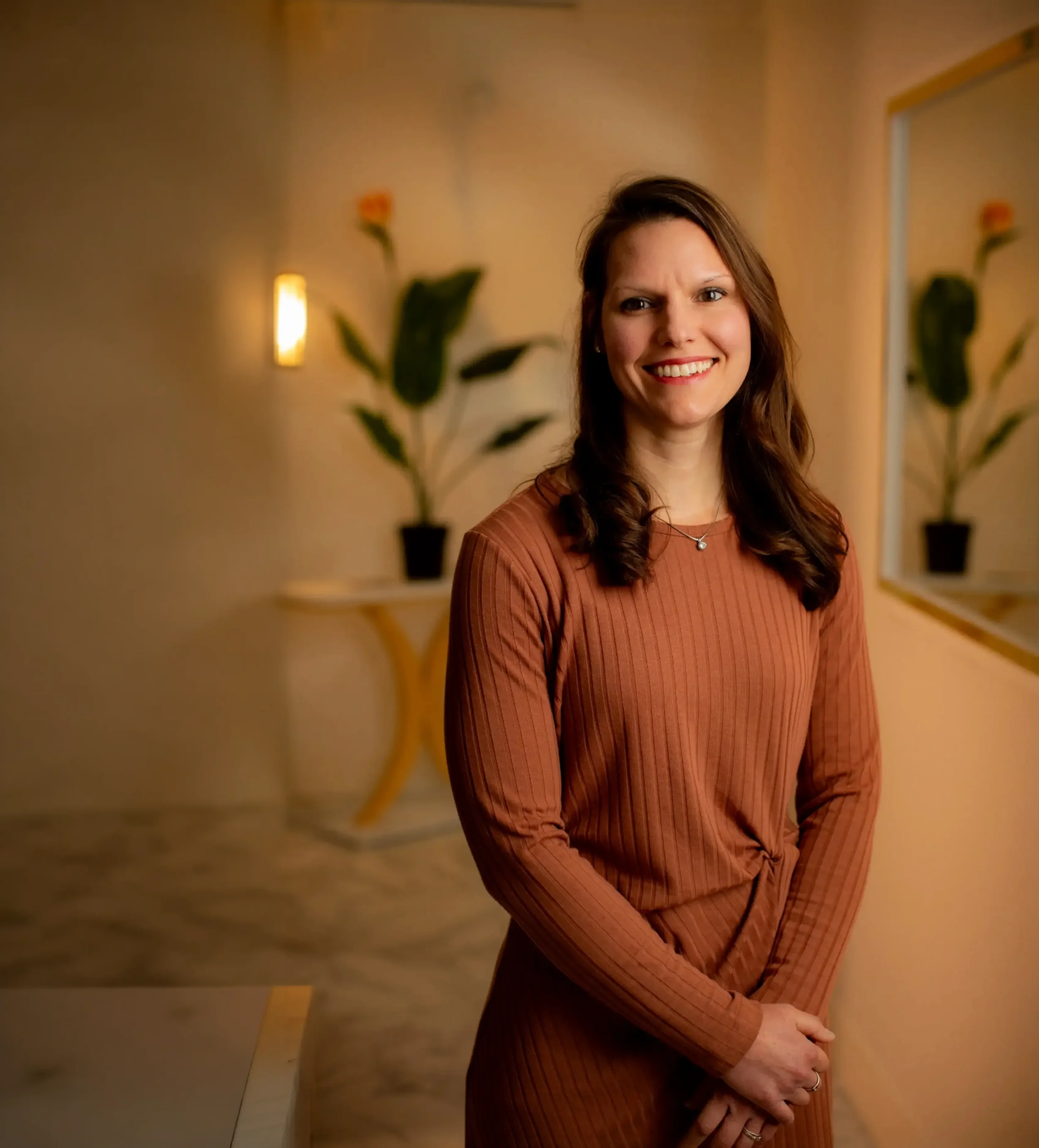 Concierge weight and metabolic health physician Dr. Anna Rusk in a rust dress at Clover Family Medicine