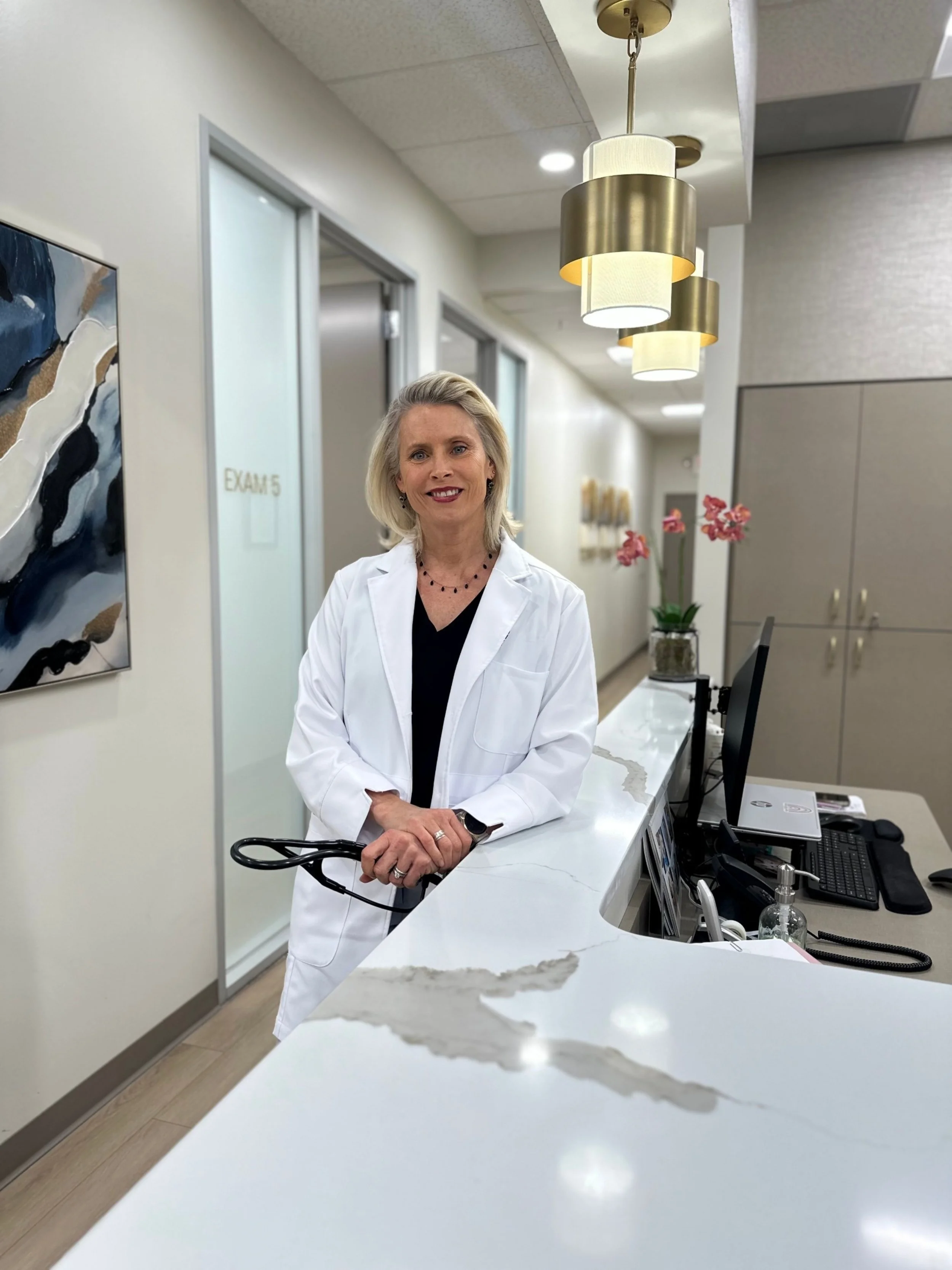 Dr. Marci Nelson, MD, MSCP at the Trillium Concierge Medicine front desk in Edmonds, WA