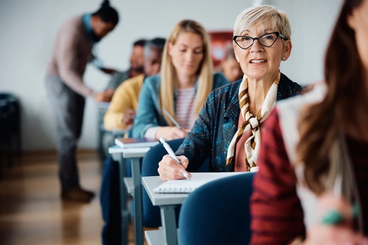 A mature woman taking a class.