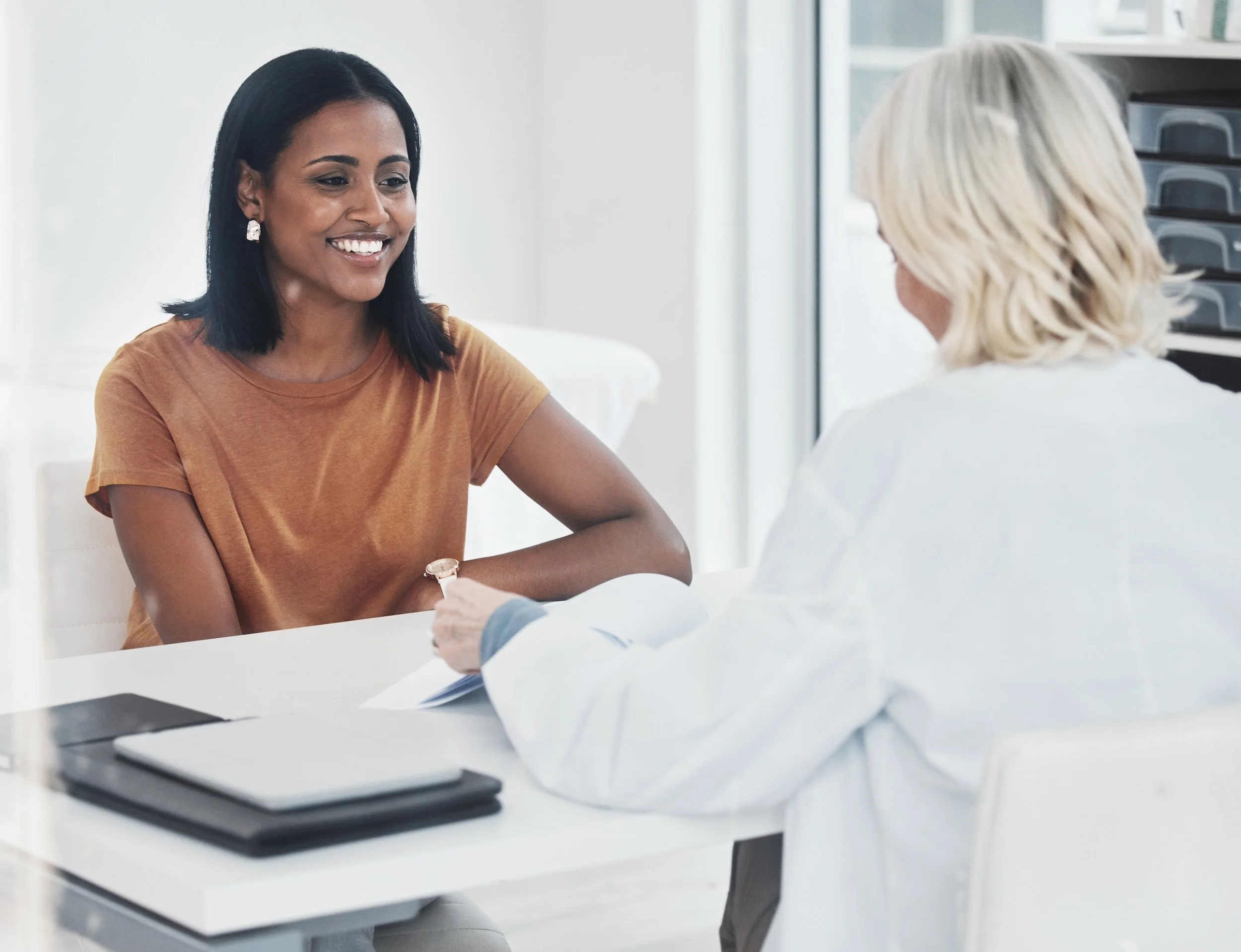 An african american woman meeting with her doctor.