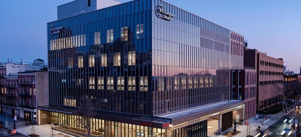 NYU Langone multispecialty center in Brooklyn with unitized glass curtainwall at dusk