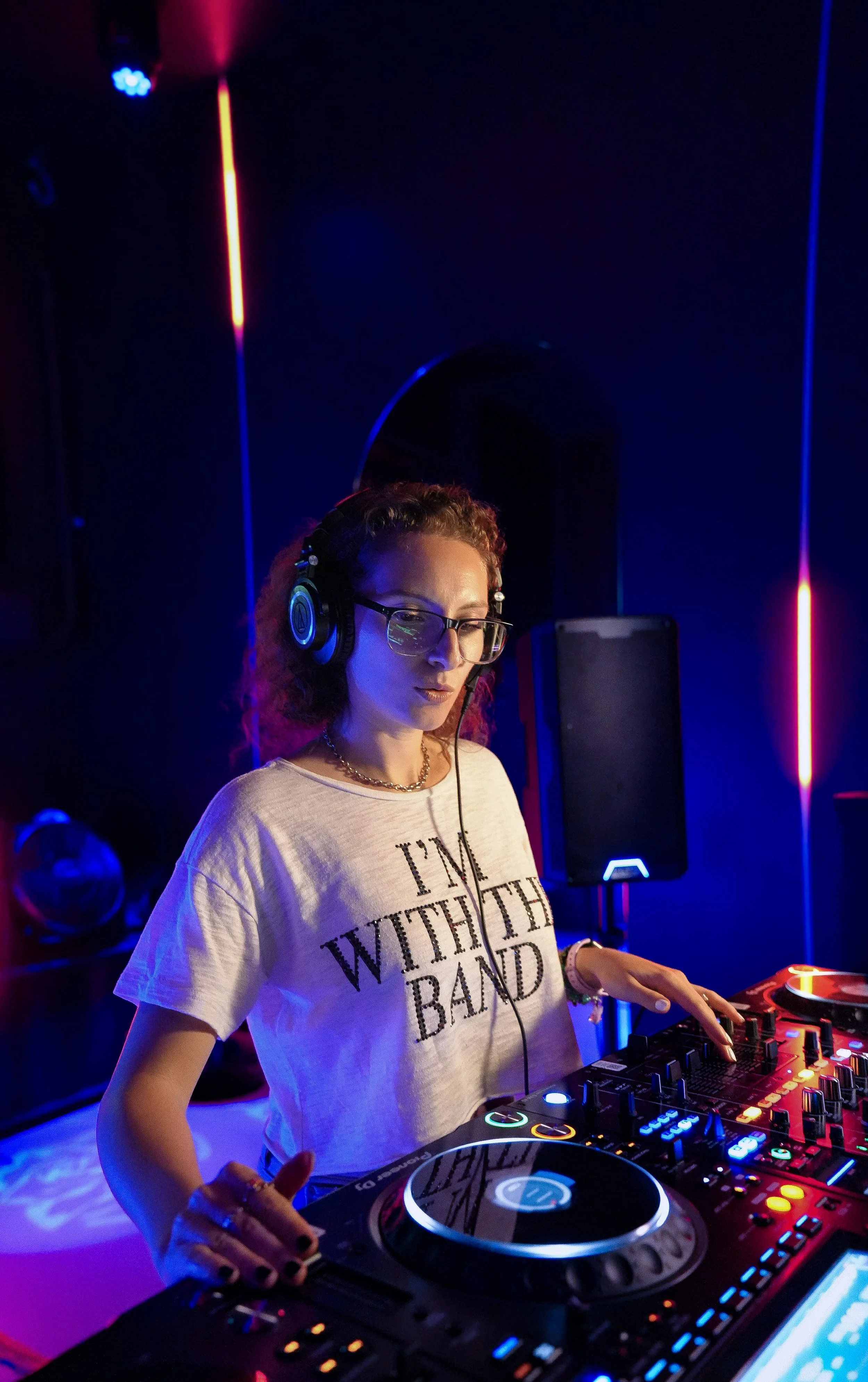 Female DJ using a professional DJ setup in a bar
