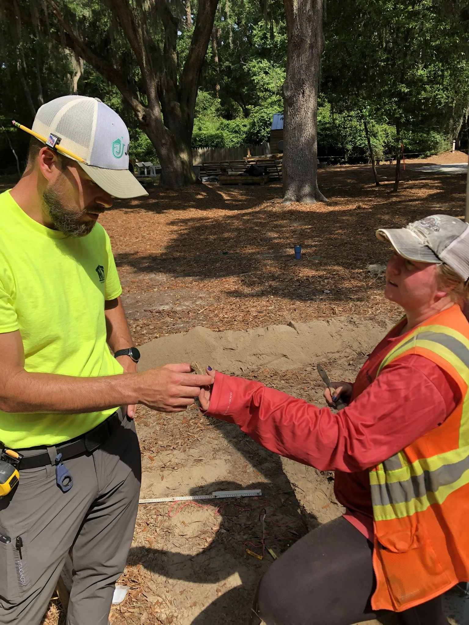 Dr. Katherine Seeber hands Nix Construction project lead Jake Rainey an artifact while working on recent excavations in the Historic Mitchelville Freedom Park. 